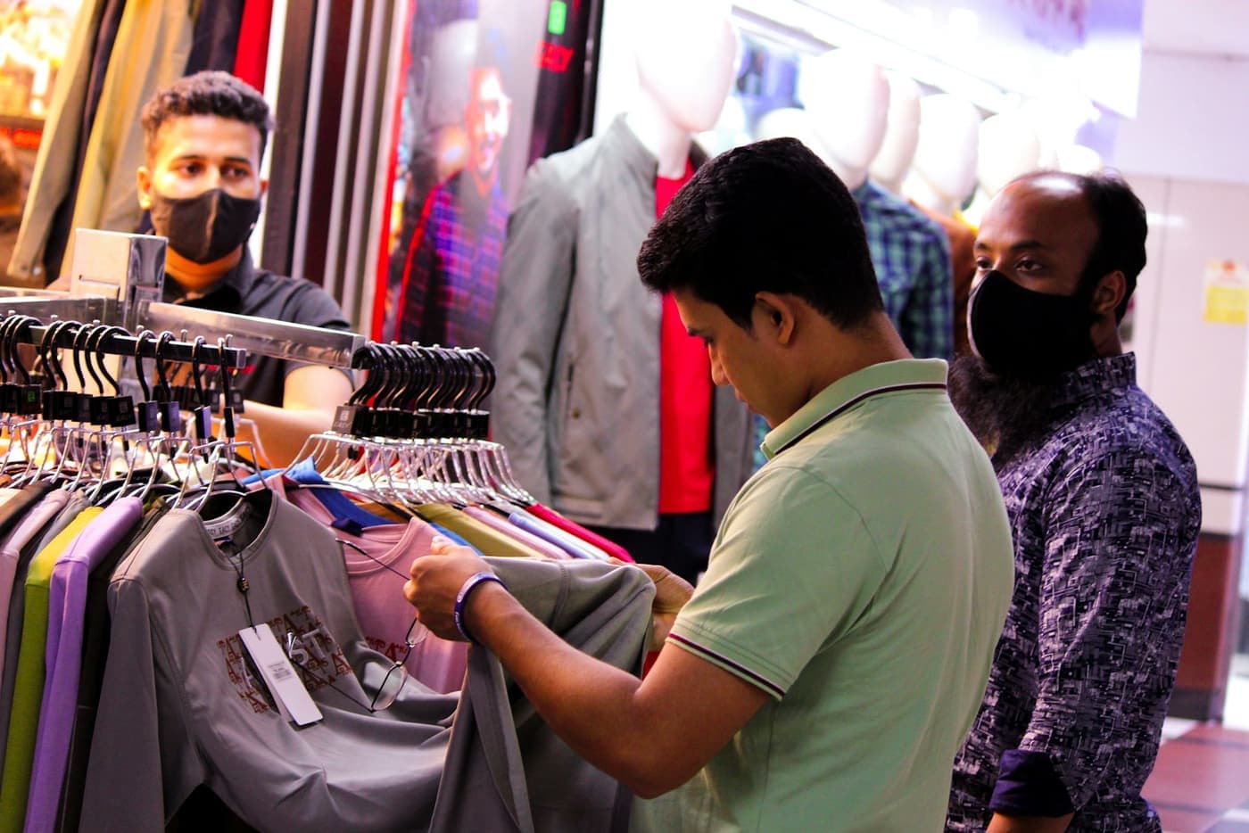 Customers looking at shirts in a clothing shop